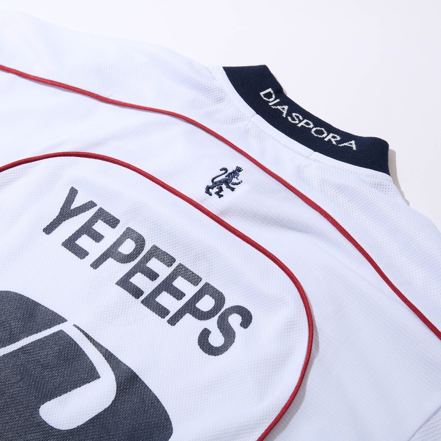 DIASPORA SKATEBOARDS/YE PEEPS Football Top